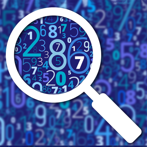 An image of scattered numbers blurred out, with a looking glass showing clear numbers. 