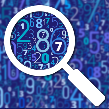 An image of scattered numbers blurred out, with a looking glass showing clear numbers. 